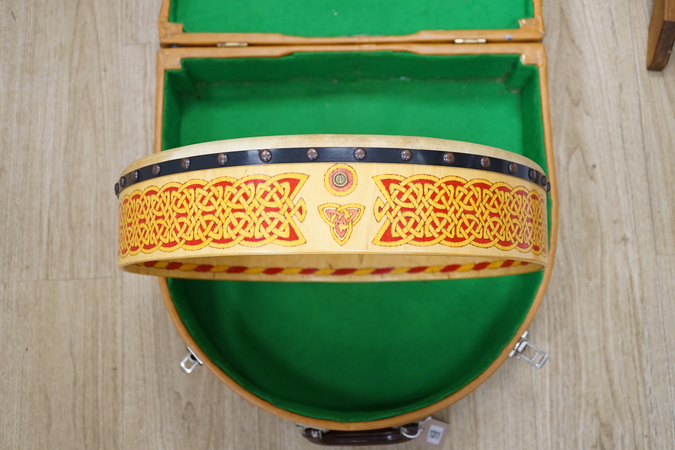 An Irish Bodhran drum with Celtic decorated plywood frame and goat skin, diameter 46cm, in fitted hard case, with beater